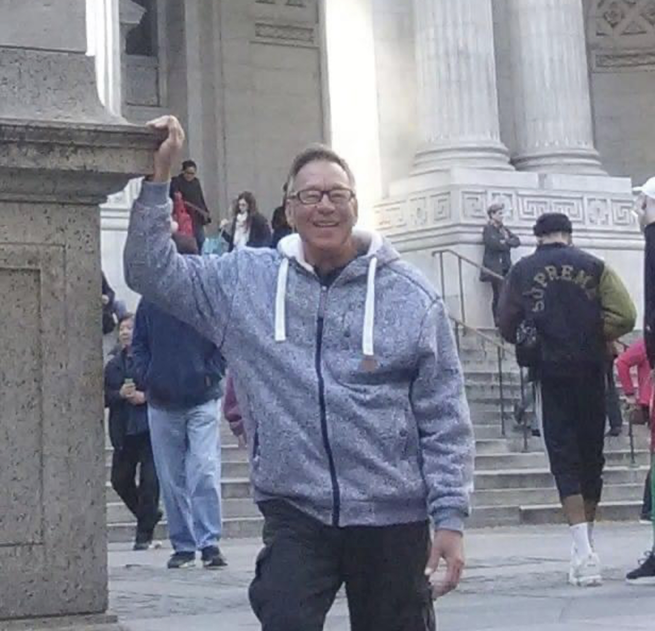 Man standing next to marble pillar