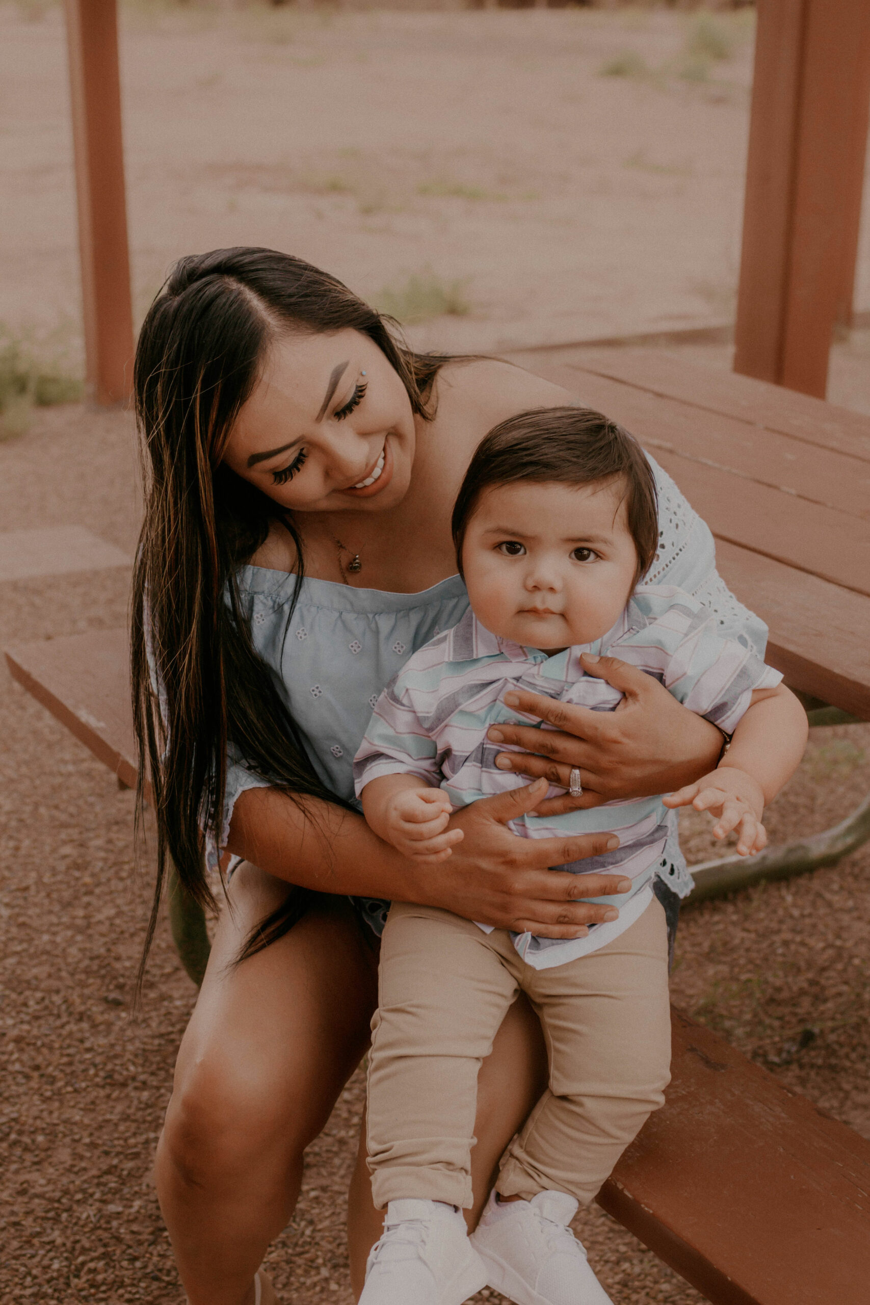 Woman with her child sitting at picnic table at Naomi house